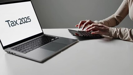 Female accountant using a calculator and laptop is calculating taxes for the year 2025, preparing financial reports and managing business expenses