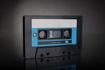 Old vintage audio cassette close up on a black background