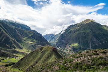 View of the Andes mountains in sacred valley, Peru with fog after a rain storm and clouds clearing up © Davslens Photography