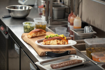 Preparing appetizing hot dogs in american diner kitchen counter