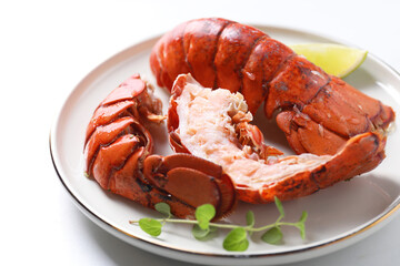 Delicious tails of boiled lobsters served on white table, closeup