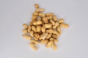 close up image of a pile of peanuts over a white background