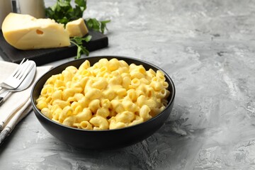 Delicious pasta with cheese sauce served on grey table, closeup. Space for text