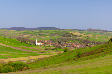 Fototapeta premium Landscape of a village in a hilly area in Romania seen from a distance