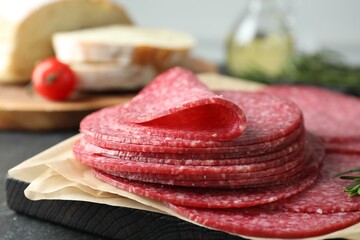 Slices of tasty smoked sausage on table, closeup
