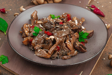 Delicious Shimeji mushrooms with chili pepper, sesame seeds and greens. Healthy Umami vegan food