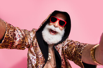 Photo of attractive grandpa take selfie photo dressed stylish leopard print garment isolated on...