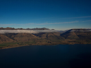 Airplane window seat panorama view of Lake Wakatipu alpine mountain landscape, Southern Alps, Glenorchy, Queenstown, Otago, South Island, New Zealand