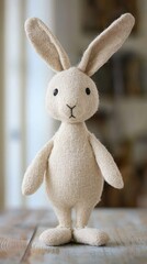 Handcrafted fabric bunny stands serenely on a weathered wooden surface