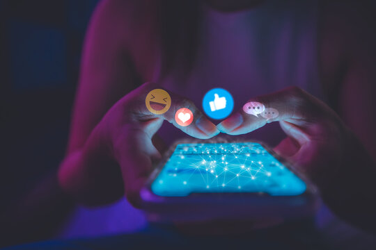 Finger of woman touching scroll page app on mobile phone.In a room with blue and purple neon tones.concept Social media and marketing