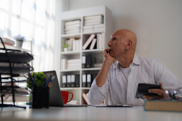 Naklejka premium Pensive businessman sipping coffee while gazing out the window on a rainy day, reflecting on the sprawling cityscape and contemplating future strategies from his office