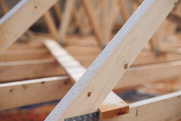 Close-up of wooden frame roof joist structure showcasing carefully aligned beams and supports