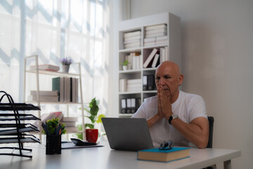 Asian businessman holding documents while standing at a modern meeting table in a sleek office, reflecting city lights on the shiny surface during a late-night work session