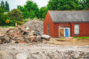 Fototapeta premium Old building site shows demolished structure with rubble and debris