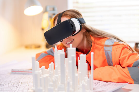 Young female engineer explores virtual reality for 3D architectural design at modern workspace