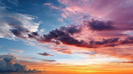 Obraz premium The radiant sunset paints the heavens in layers of warm and cool tones, creating a stunning, atmospheric backdrop full of wonder and serenity.