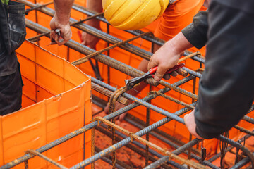 Steel fixer assembling rebar cage for reinforcing concrete structure