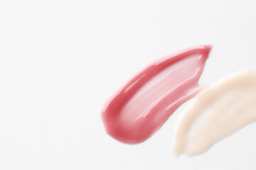 Samples of lip balms on white background, top view. Space for text