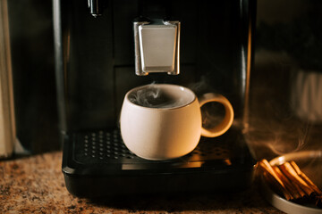 Preparing a warm cup of coffee in a cozy kitchen at early morning