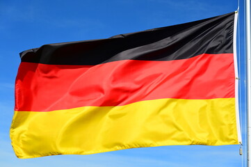 flag of Germany fluttering in blue sky