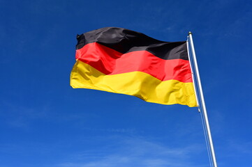 flag of Germany fluttering in blue sky