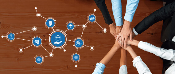 A vibrant scene showing multiple hands joining above a wooden table, symbolizing unity and...