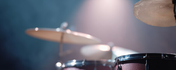 Obraz premium Modern drum kit on festival stage with intense backlighting