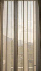 Tranquil Home Interior with Gentle Sunlight and Flowing Window Treatments