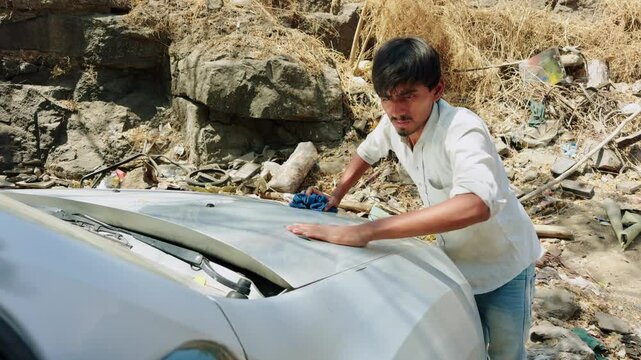 Mechanic buffs vehicle with coarse sheet calmly