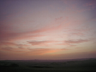 Orange sunset in the Ica desert - analog photo style.