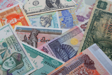 stacks of banknotes from various countries in the world