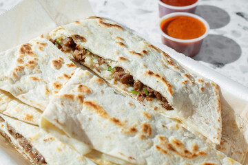 A closeup view of an asada quesadilla.