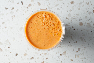 A top down view of carrot juice.