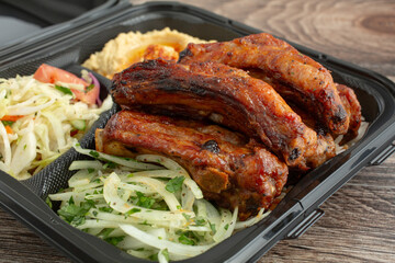 A closeup view of a pork ribs combo plate.