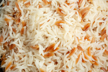 A top down view of a layer of rice pilaf, as a background.