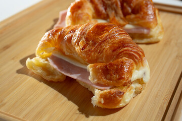 A view of a ham and cheese croissant sandwich.