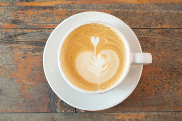 A top down view of a cappuccino in a ceramic mug.