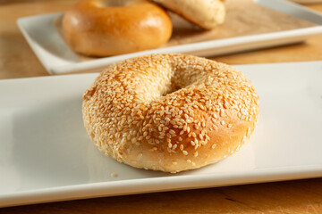 A view of a sesame seed bagel, on a plate.