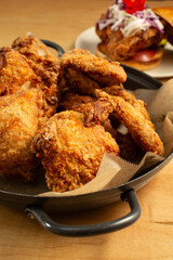 A view of a large bowl of fried chicken.