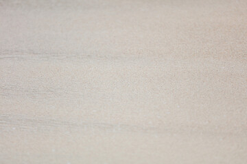 A white sandy beach with a few footprints in the sand
