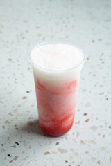 A view of a strawberry lychee fruit tea beverage.