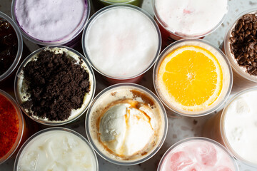 A top down view of several boba drinks, as a background.