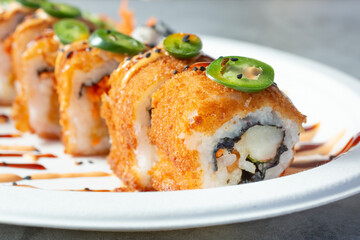 A closeup view of a deep fried sushi roll.