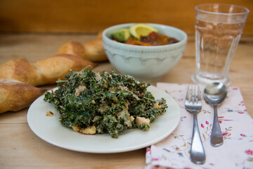 Wholesome Vegan Meal with Kale Salad, Chili, and Fresh Bread