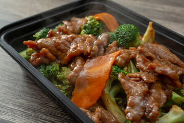 A closeup view of a container of beef broccoli.
