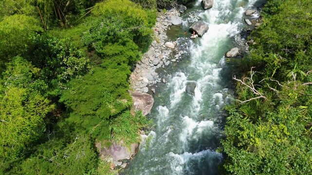 Scenic Aerial View from River Through Jungle to Andes Mountains, Pance River, Farallones de Cali, Colombia. High quality 4k footage