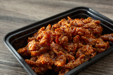 A closeup view of a container of orange beef.
