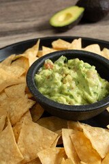 A view of a platter of guacamole and tortilla chips.