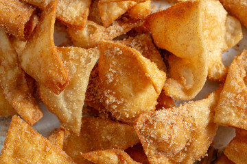 A top down view of a pile of bunuelos, as a background.