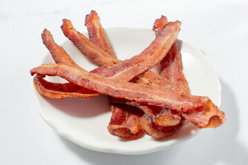 A closeup view of a pile of bacon strips.